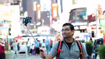 A tourist takes a selfie in New York City.