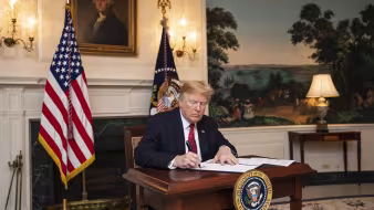 President Trump signs an immigration proclamation at the White House