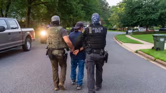 Federal immigration officers make an arrest during an operation in Virginia.