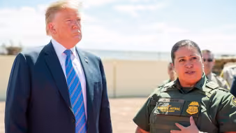 President Trump and a Customs and Border Patrol officer stand together