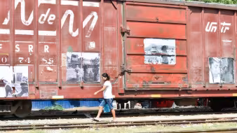 A woman walks alongside a train in Mexico.