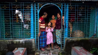 A returned migrant with his family in Bangladesh