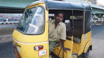 A tuk tuk driver in India.