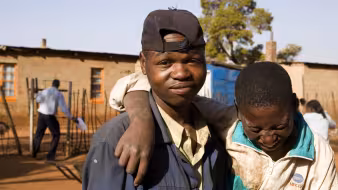 Two boys pose in an informal settlement east of Johannesburg largely populated by immigrants.