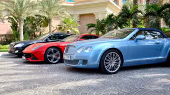 Luxury cars in front of a hotel on Dubai's Palm Jumeirah.