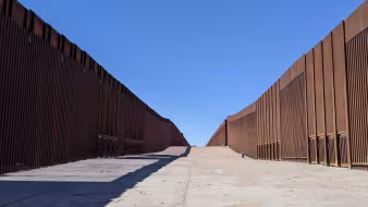 A double border wall leads to a boat launch in Yuma, Arizona.