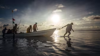 A man pulls a boat on the low-lying Carteret Islands in Papua New Guinea