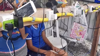 Venezuelan migrants charge their phones and other devices at a power point in Boa Vista, Brazil.