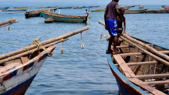Boys on a fishing boat on the shores of Lake Tanganyika