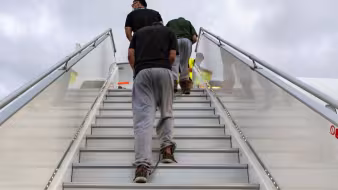 Migrants being deported from the United States to Mexico. 