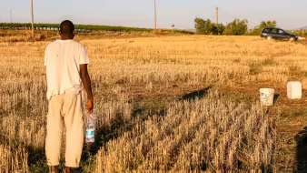 A farmworker from Africa in a field in Southern Italy.