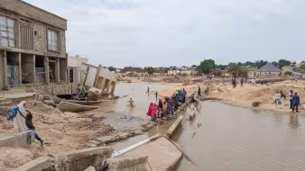 People walk through floodwaters in Nigeria.