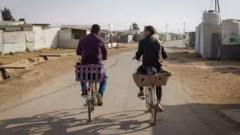 People ride bicycles in the Za'atari refugee camp in Jordan.