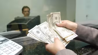 A woman receives remittances from a family member abroad.