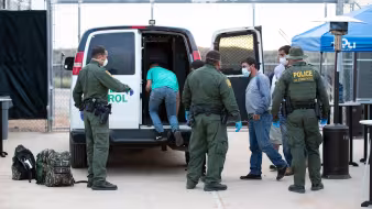 U.S. Border Patrol agents prepare to transport unauthorized migrants to Mexico under Title 42.