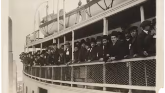 Immigrants arriving on a ferry near Ellis Island.
