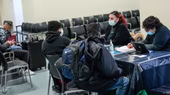 Asylum seekers receive assistance at the Brooklyn Cruise Terminal in New York City.