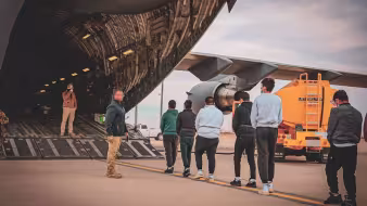 Noncitizens being deported to Ecuador board a military plane in Texas.