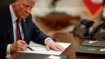 President Donald Trump signs an executive action
