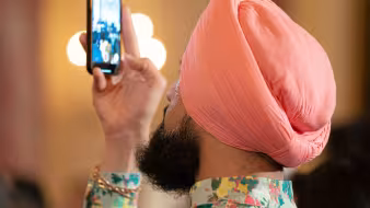 A guest takes a photo at a Diwali reception at the White House. 