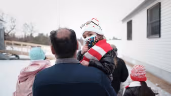 A family of Afghan evacuees leaving Fort McCoy, Wisconsin.
