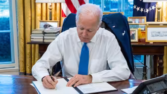 President Joe Biden signs an executive order.