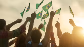 People hold Brazilian flags