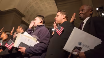 New U.S. citizens take an oath during a naturalization ceremony.