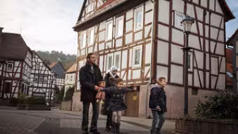 A family from Syria walks through the town of W&auml;chtersbach, Germany, where they now live.