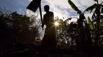 A farmer in Tanzania tends to crops.