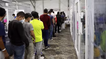 Unaccompanied minors undergo processing at a temporary facility in Texas.
